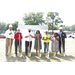 a smiling group of people posing with shovels