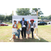 four women and a man posing with hard hats