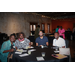 4 people smiling at a table