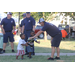 Firemen playing football with little boys