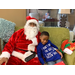 Santa posing with little boy on couch