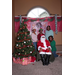 4 people posing behind seated Santa and Christmas tree