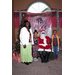 Woman with boy and girl smiling with Santa for picture