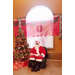 Santa in an easy chair in front of window and Christmas tree