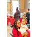 Woman holding little girl with presents table behind