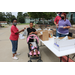 Kid pushing stroller receiving giftbag