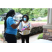 guest in mask receiving gift bag