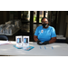 Envolve staff  member at table with tablets and gift bags