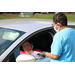 guest filling in clipboard in their car