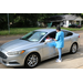 guest's car with staff member delivering giftbag