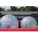 Kids playing in a big inflatable bumper ball