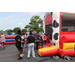 Families gather around a bounce house