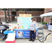 A woman standing in front of a Nurses Ministry Booth.