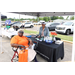 Two ladies at a booth. One is sitting down in a wheelchair.