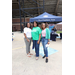 A group of three ladies standing in a parking lot.