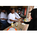 A woman serving two hotdogs to a customer. 