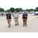 Three police officers smile together. 