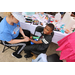 A little boy getting his hand painted on.