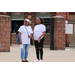 Two women standing at an entrance.