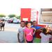 Three kids in front of a food truck. 