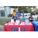 People posing behind a TRIO display table. 