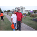 A man and a woman on the sidewalk getting a photo. 