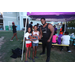 Man and young girls holding up a wrestling belt. 