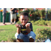 Young boy crouched and posing for his picture. 