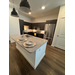  Remodeled kitchen with place settings on the island at the grand opening of waterview crossing. 