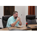  Craig Manning sitting in the conference room. 